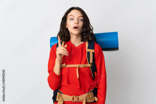 Teenager mountaineer girl with a big backpack isolated on white background intending to realizes the solution while lifting a finger up