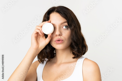Teenager Ukrainian girl isolated on white background with moisturizer