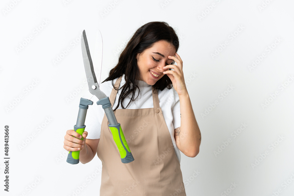 Young caucasian woman holding a plant isolated on white background laughing Young caucasian woman holding a plant isolated on white background laughing