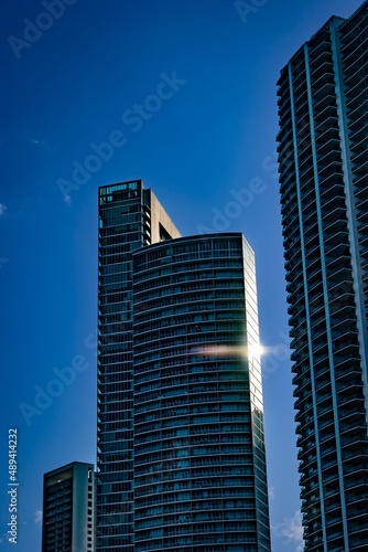 Sun reflection on windows of tall condominiums building in downtown Miami, South Florida