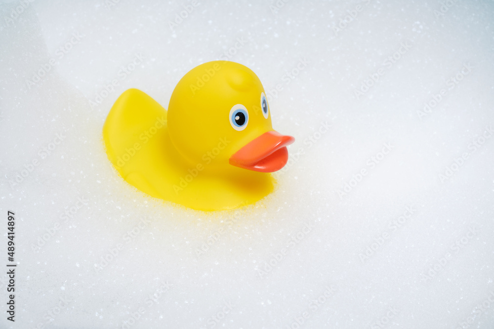 Yellow duckling is bathing in bubble bath. Yellow duckling is bathing in bubble bath.