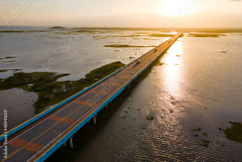 Aerial view of Ekachai Bridge or Chaloem Phrakiat 80 Phansa Bridge at sunset. Located in Thale Noi, Connect between Phatthalung and Songkhla province in Thailand. photo