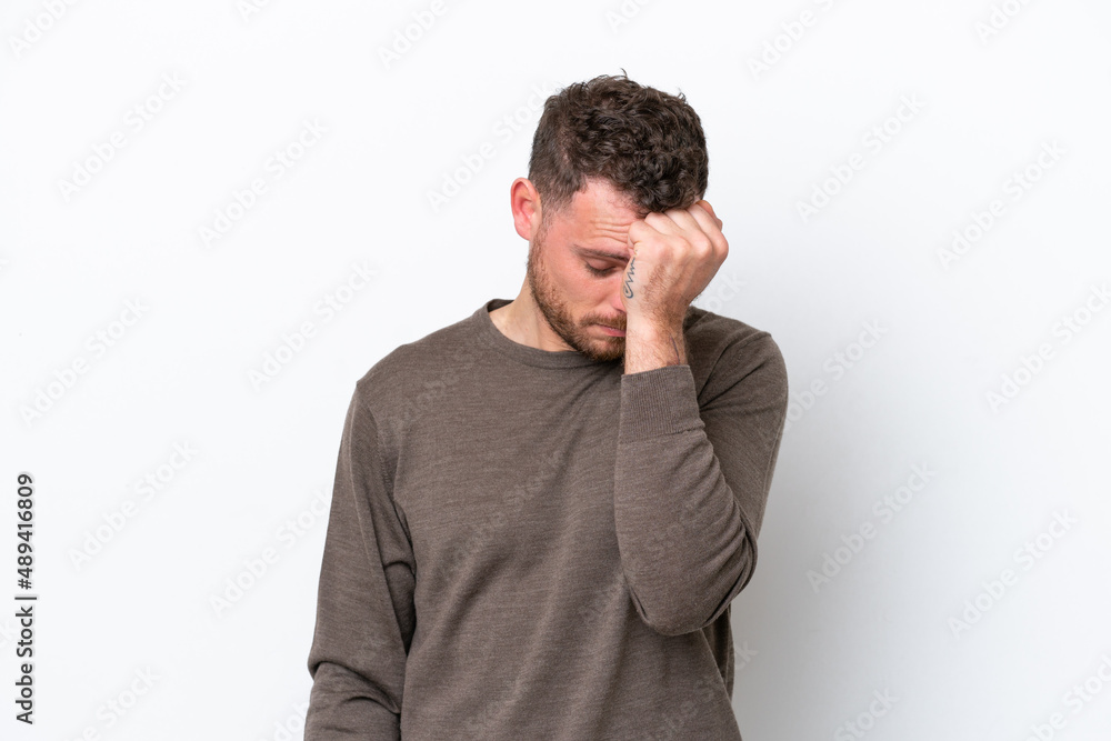 Young Brazilian man isolated on white background with headache Young Brazilian man isolated on white background with headache