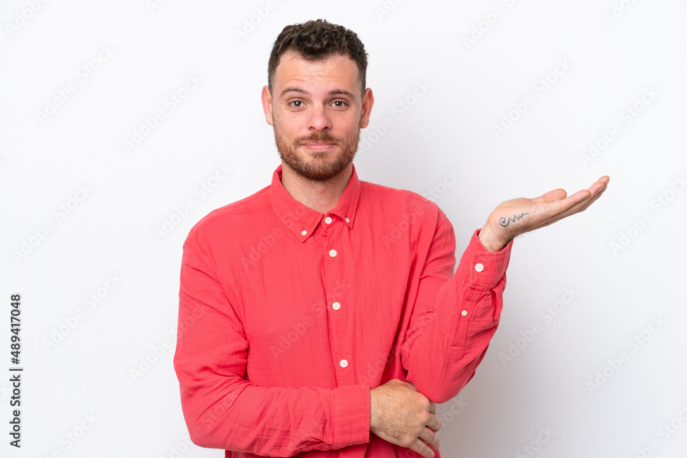 Young Brazilian man isolated on white background having doubts Young Brazilian man isolated on white background having doubts