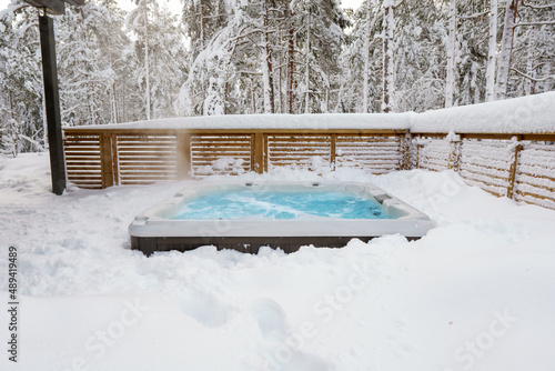 The warm hot tub invites you to relax in the beautiful winter landscape as the snow slowly falls down.