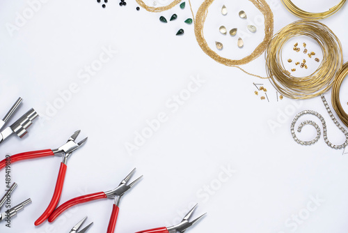 Top view of hand tools to make jewelry on white background with space for text