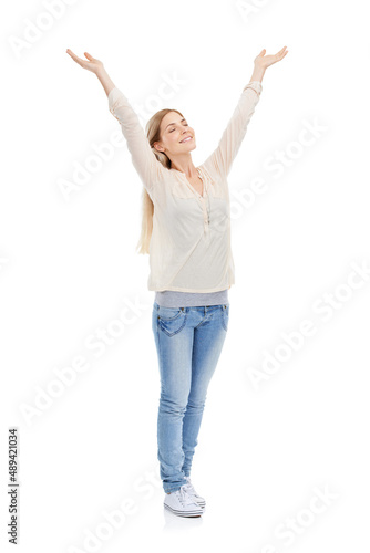 Somedays its just great to be alive. Full length studio shot of a young woman with her eyes closed raising her arms over her head isolated on white.