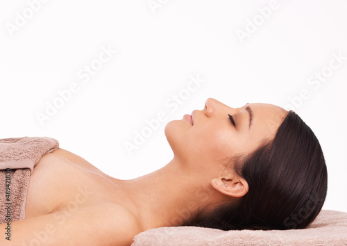 Heaven on earth. A beautiful young woman relaxing on a massage table before her massage.