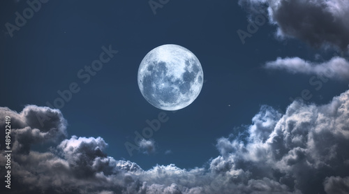 The Moon surrounded by clouds. A photo of the moon surrounded by friendly clouds.