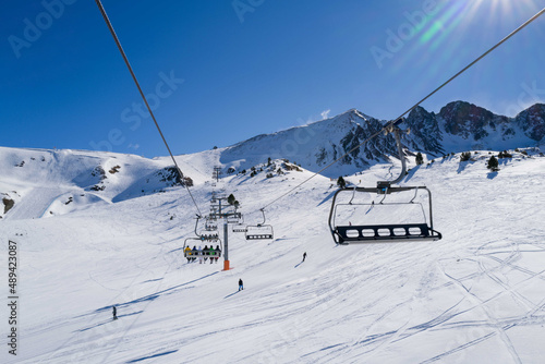 People riding ski lift in ski resort