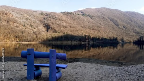 Relaxing Landscape with Purple Bench on Lake Ghirla photo