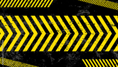 A grungy and worn hazard stripes texture. Abstract warning striped rectangular background, yellow and black stripes on the diagonal, a warning to be careful