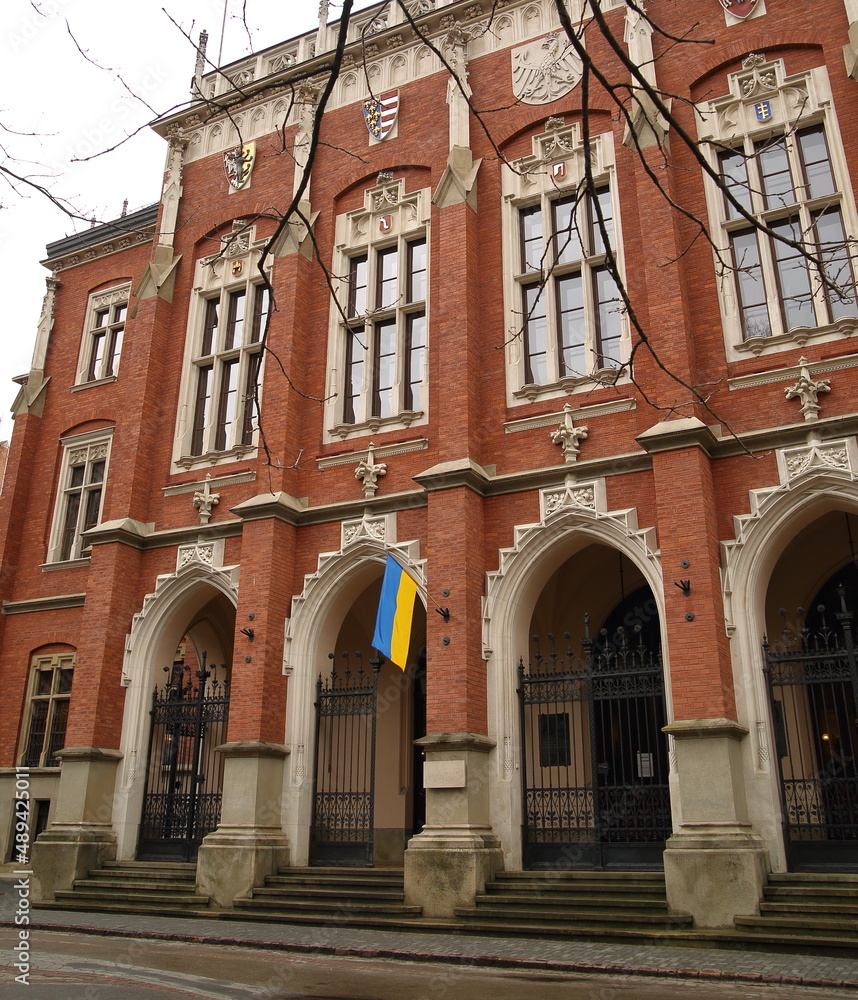 Main building of Jagiellonian University in Krakow, Poland, decorated with flag of Ukraine to show solidarity with country attacked by Russia