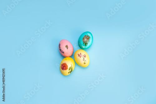 Bright multi-coloured painted Easter eggs on a blue background. Easter