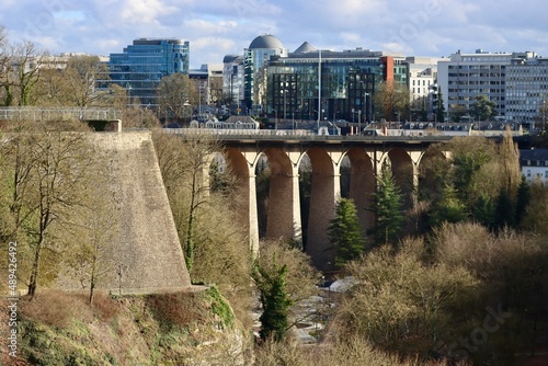 Old city fortifications, La Passerelle arched viaduct over Petrusse river valley, and modern buildings of Gare district in Luxembourg on an early spring day. 