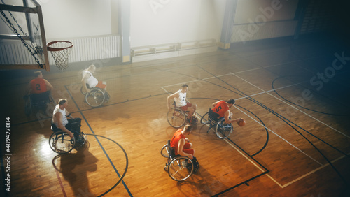 Wheelchair Basketball Game Court: Paraplegic Professional Players Competing, Passing, Shooting Ball. Determination, Inspiration, and Skill of a People with Disability. photo