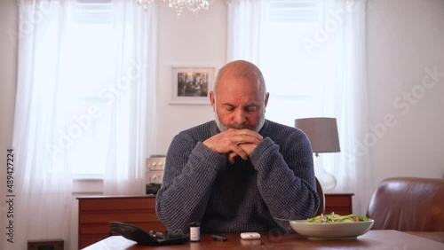 A diabetic man testing his blood sugar at home.  He is upset that his blood glucose levels are not good. A real person with Type 2 diabetes.