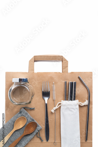 reusable items - glass, iron objects, wooden spoons, paper bag