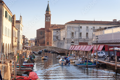 View of town Chioggia with canal Vena and church steeple of Chiesa della Santissima Trinita in Veneto, Italy photo