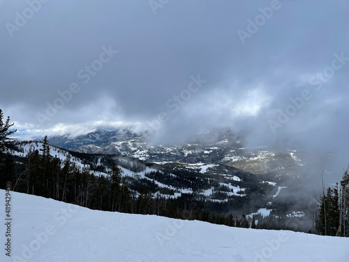 Scenic view of snow covered slopes at a ski resort in Montana on a cloudy winter day