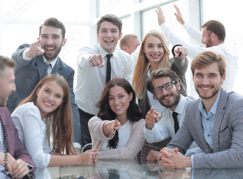 group of young employees are pointing at you