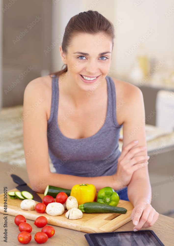 Online recipes. Portrait of an attractive young woman looking for recipes online while cooking.