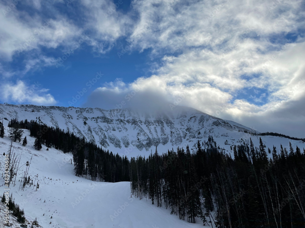 Scenic view of clouds and snow covered mountains at Big Ski Ski Resort on a winter day