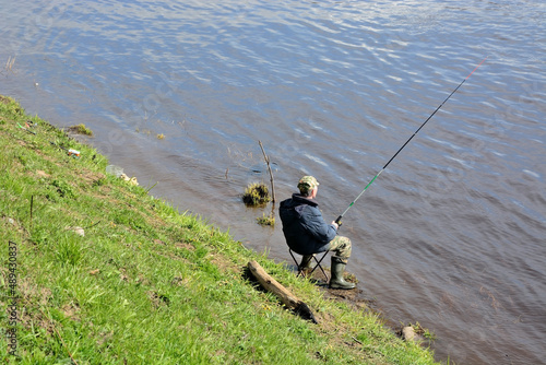 VOLKHOV, RUSSIA- MAY 08, 2017: A fisherman catches a fish called sopa (blue bream) on the Volkhov River, Russia, Staraya Ladoga. spring season photo
