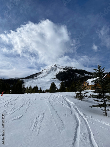 Scenic view of the snow covered slopes and mountains at Big Sky Ski Resort in Montana on a sunny winter day