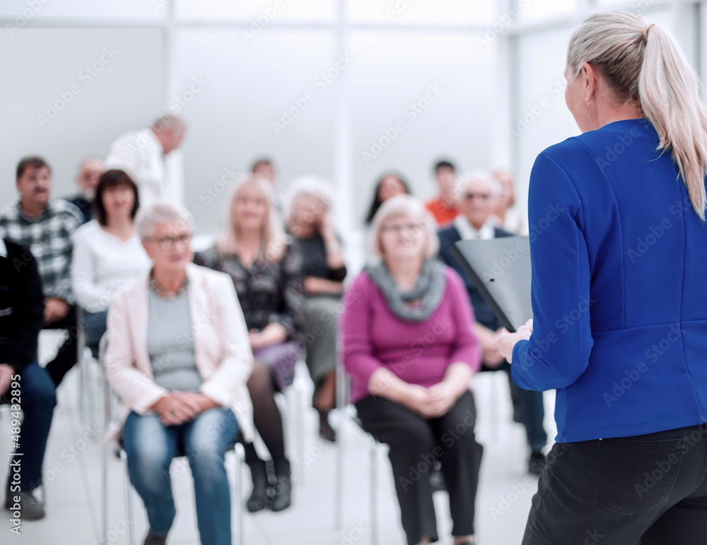 Businesswoman addressing colleagues at office meeting Businesswoman addressing colleagues at office meeting