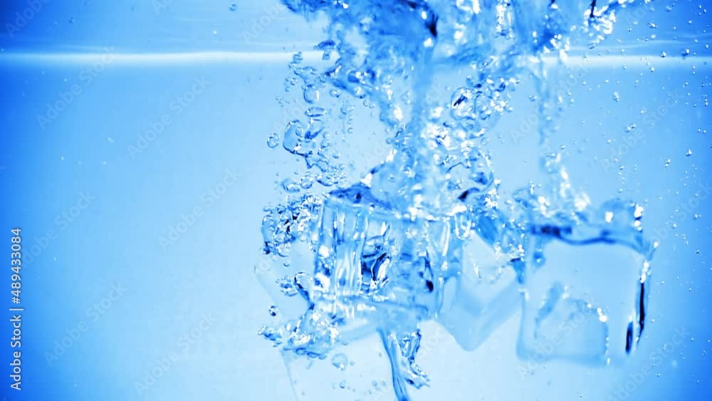Ice cubes dropped into water with air bubbles. Ice cubes dropped into water with air bubbles.