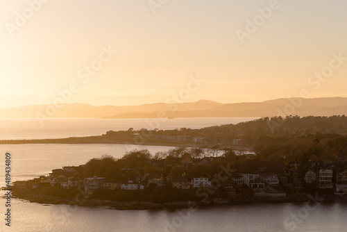 High angle north-west view of the Oak Bay residential area  with creeks in soft focus background during a hazy winter sunset from the Walbran Park Lookout  Victoria  British Columbia  Canada