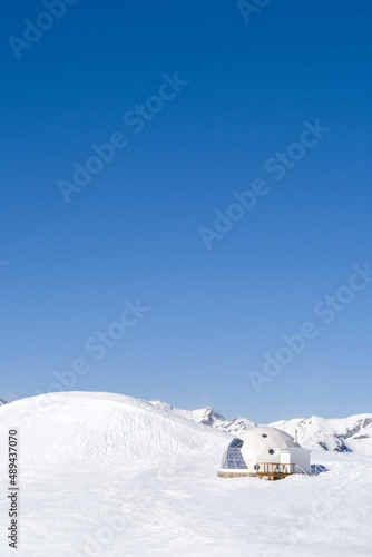 Snowy igloo on the mountain slope
