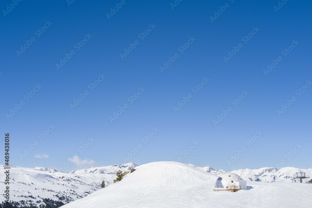 Snowy igloo on the mountain slope