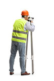 Rear view of a geodetic surveyor using a measuring instrument