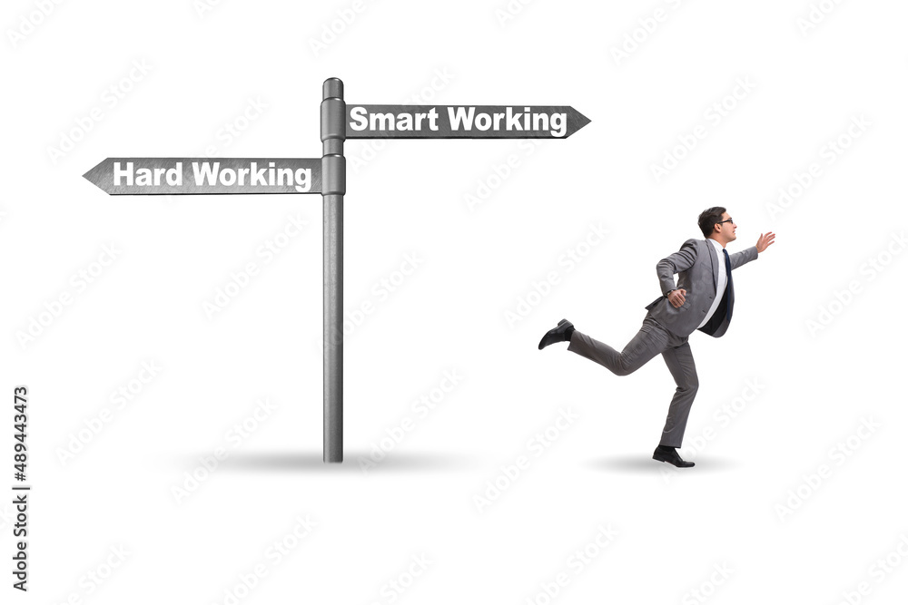 Businessman at the crossroads on working smart or hard Businessman at the crossroads on working smart or hard
