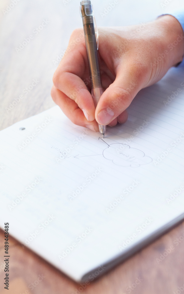 Lets get planning. Cropped shot of a businessman writing on a notepad. Lets get planning. Cropped shot of a businessman writing on a notepad.