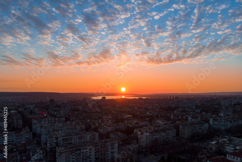 Cityscape from above. Sunset with dramatic clouds with drone