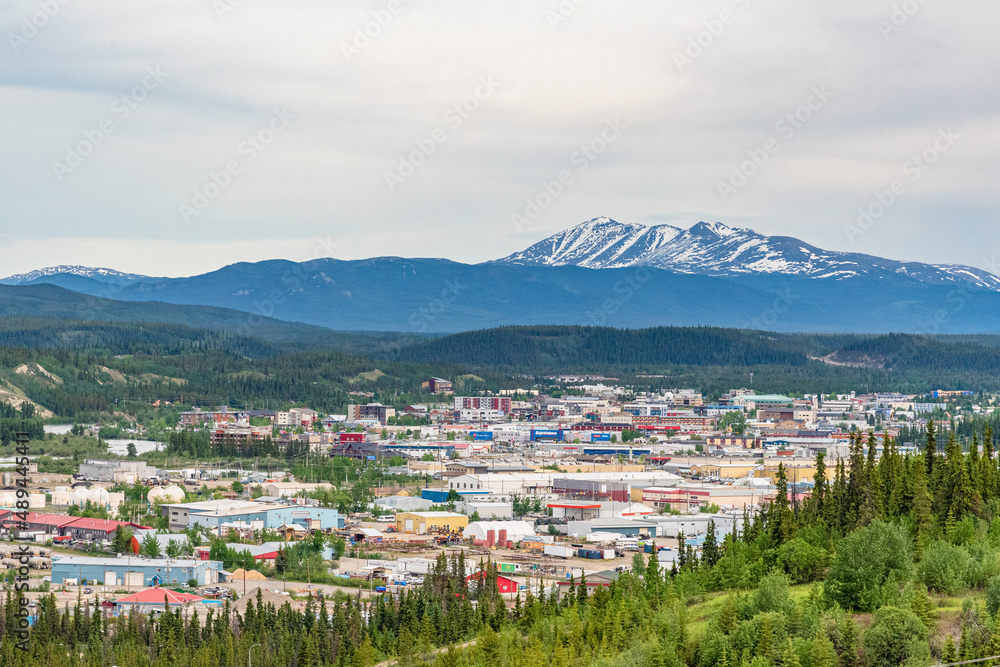 City of Whitehorse in Yukon Territory, capital city in Canada. During summer time with snow capped mountain in background. 