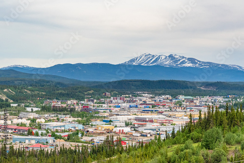 City of Whitehorse in Yukon Territory, capital city in Canada. During summer time with snow capped mountain in background.  photo