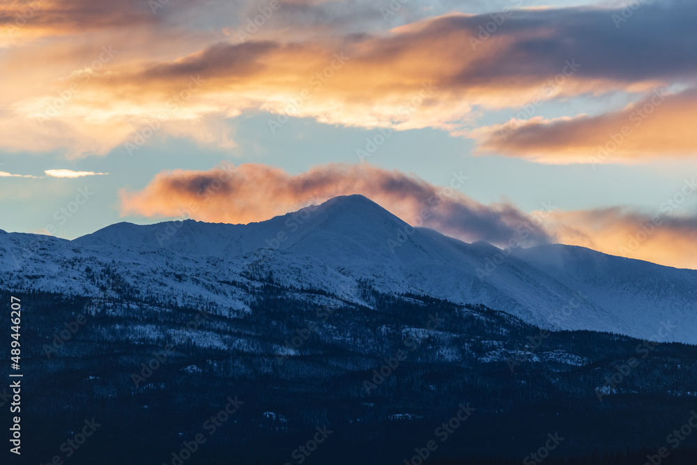 Wilderness area, isolated rural land in northern Canada with no people, no life. Nothing but nature, mountains in the distance at sunset with pink, orange hues. Wilderness area, isolated rural land in northern Canada with no people, no life. Nothing but nature, mountains in the distance at sunset with pink, orange hues.