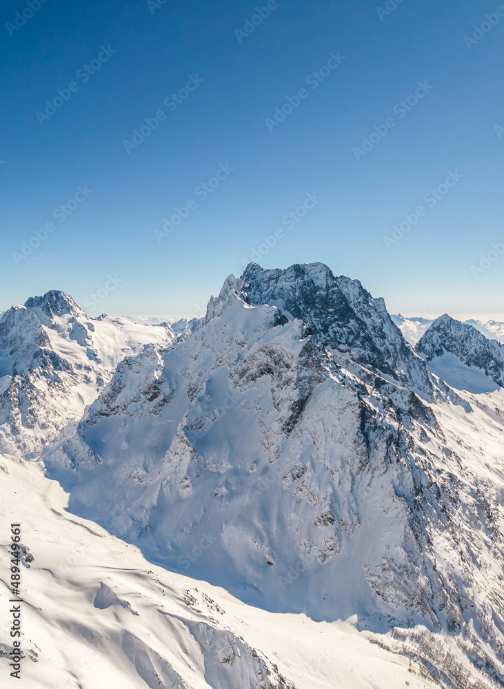 Mountain peak covered with snow under a clear sky 