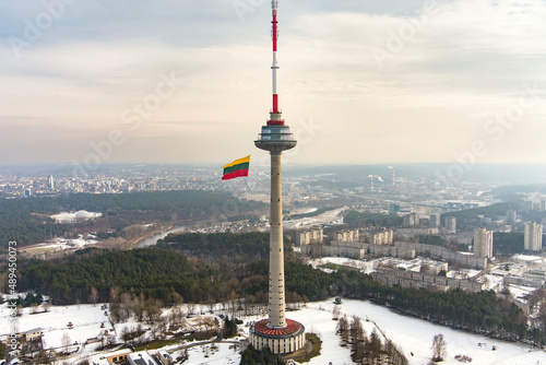 VILNIUS, LITHUANIA - FEBRUARY 16, 2022: Giant tricolor Lithuanian flag waving on Vilnius television tower on the celebration of Restoration of the State Day.