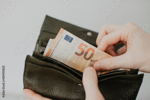 euro money are taken out of the wallet, close up