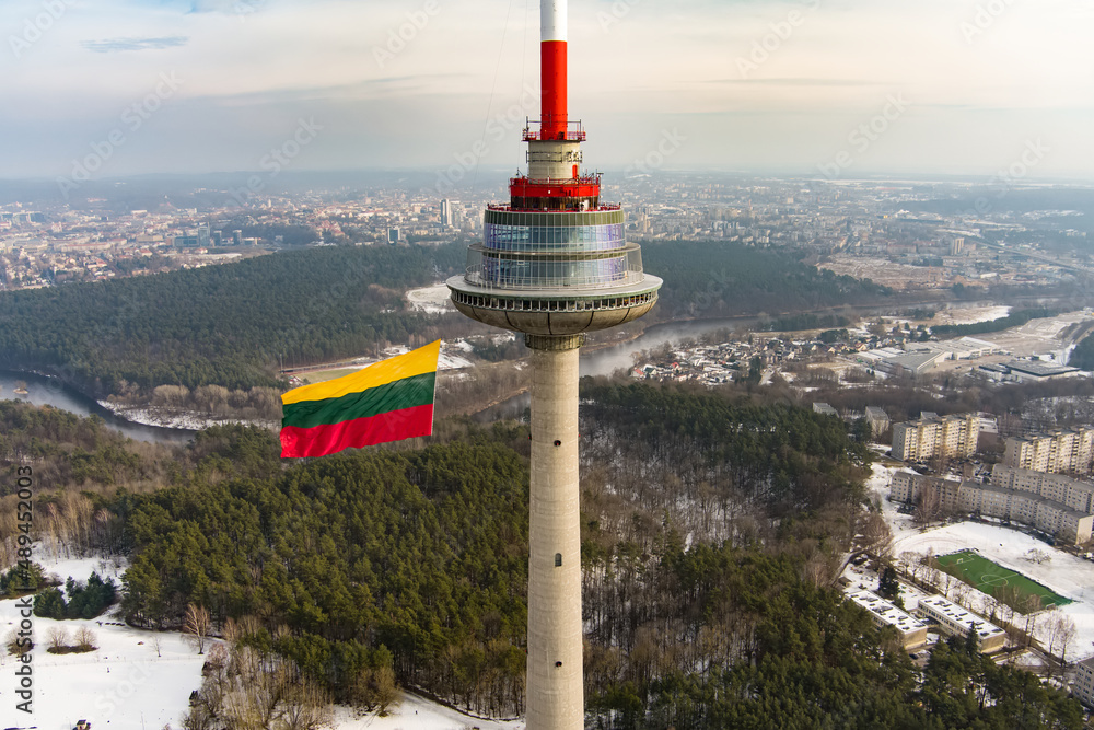 Obraz na płótnie VILNIUS, LITHUANIA - FEBRUARY 16, 2022: Giant tricolor Lithuanian flag waving on Vilnius television tower on the celebration of Restoration of the State Day. w salonie