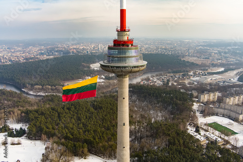 VILNIUS, LITHUANIA - FEBRUARY 16, 2022: Giant tricolor Lithuanian flag waving on Vilnius television tower on the celebration of Restoration of the State Day.