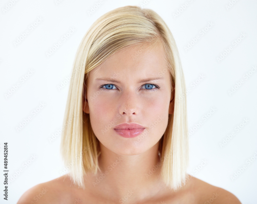 Framing natural beauty. Head and shoulders portrait of a pretty young blonde staring at your seriously. Framing natural beauty. Head and shoulders portrait of a pretty young blonde staring at your seriously.