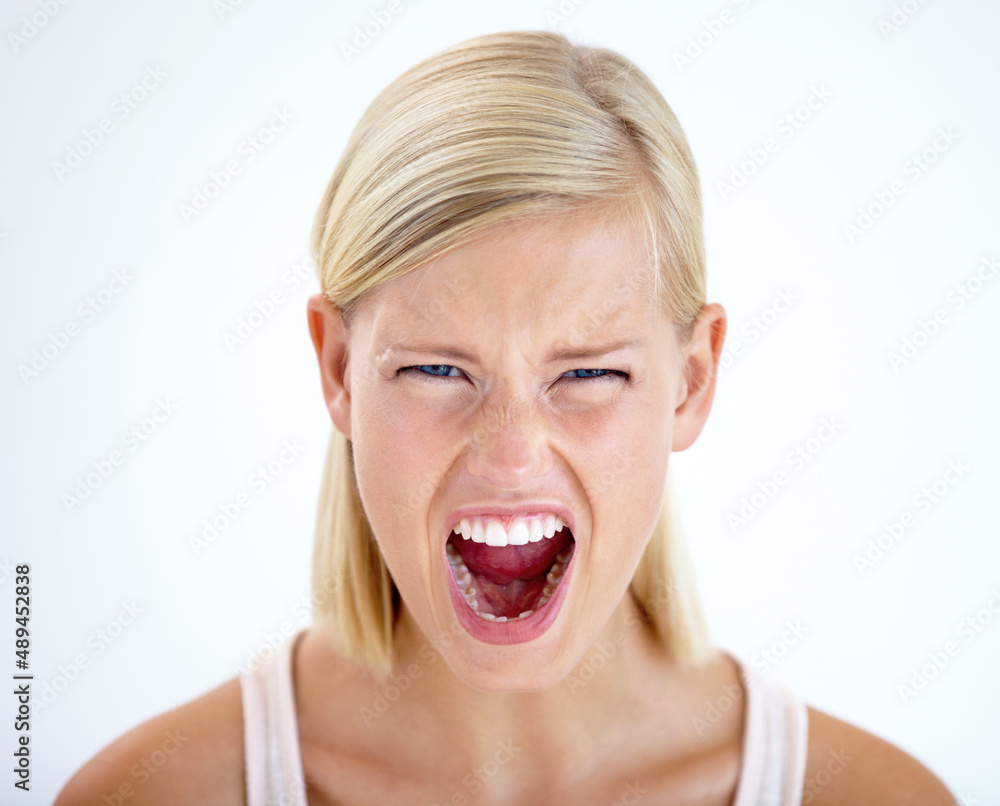 RAGE. Head and shoulders portrait of a furious woman screaming loudly. RAGE. Head and shoulders portrait of a furious woman screaming loudly.
