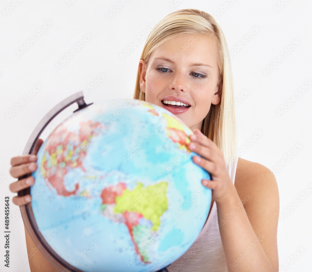 Ah, heres a place I havent explored yet. A pretty young woman looking at a globe of the earth. Ah, heres a place I havent explored yet. A pretty young woman looking at a globe of the earth.