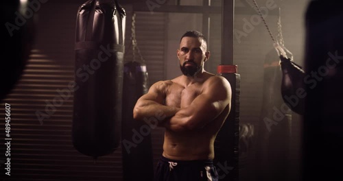 A Dramatic Portrait Of A Heavyweight Hispanic Bodybuilder / Weightlifter. Shot In A Crossfit Boxing Gym With Low Key Lighting And A Scattering Of Haze. Captured On Red Digital Cinema Camera 